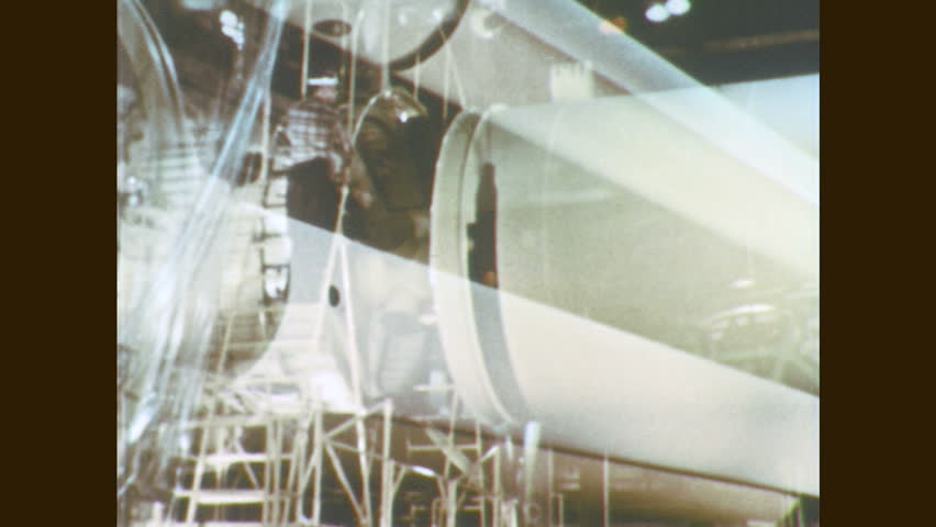 1960s: Rocket booster tank is moved by crane. Man works on rocket manifold. | Shutterstock HD Video #28250674