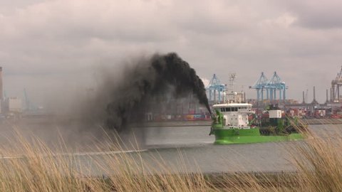 ROTTERDAM SEAPORT - MAY 2017: dredging operation of hopper dredger Reynaert, rainbowing black mud when the deepening of Alexia Haven, Maasvlakte II