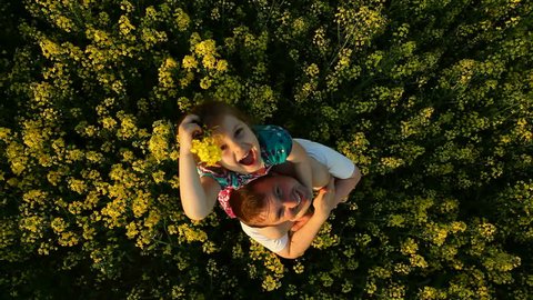 Dad and daughter in a field of flowers