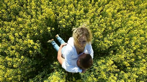 Couple in a rape field, view from above