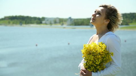 girl with flowers on the beach
