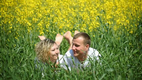 young couple in rapeseed field