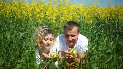 young couple in rapeseed field