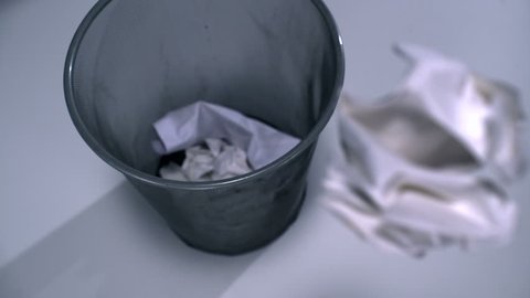 Tossing crushed paper into garbage can shooting with high speed camera, phantom flex.