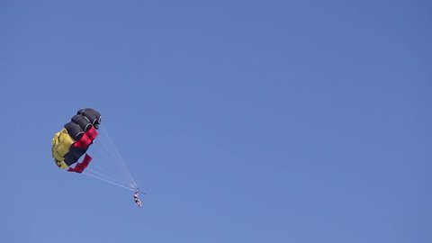 Parachute flying above the sea. The boat pulls the parachute. A parachute in the sky above the sea. The parachute rises. Flight in the sky, High, bottom view