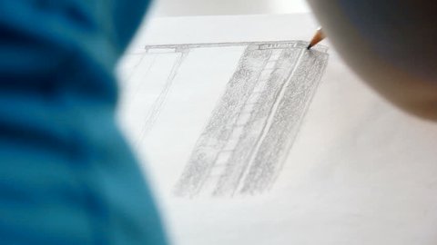 Drawing a business skyscraper with pencil and without other tools. Young woman wanted to be an architect.