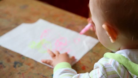 beautiful little girl draws picture