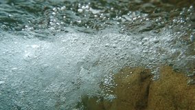 SLOW MOTION of Bubbles under the water. Bubbles under waterfall closeup