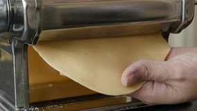 Italian lasagna process with kitchen helper 4K 2160p 30fps UltraHD footage - Close-up of manual pasta machine using at home 3840X2160 UHD video