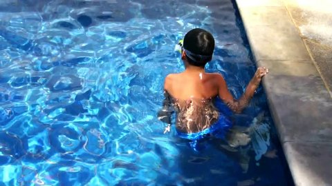 Young boy swimming in the pool
