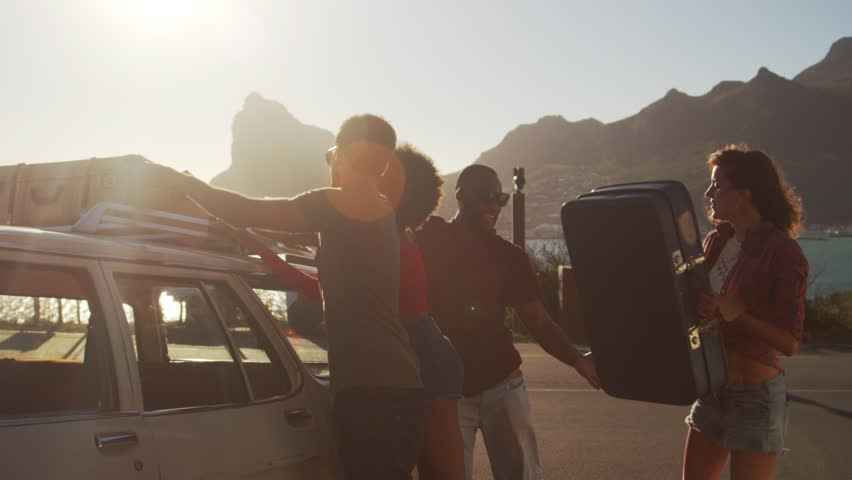 Friends Loading Luggage Onto Car Roof Rack Ready For Road Trip | Shutterstock HD Video #28275166