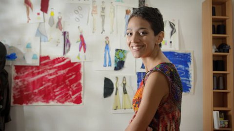 Confident entrepreneur, portrait of happy hispanic young woman working as fashion designer and dressmaker in atelier : vidéo de stock