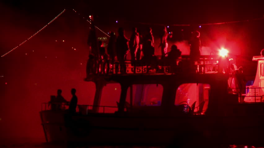 fireworks boat in foreground red people
