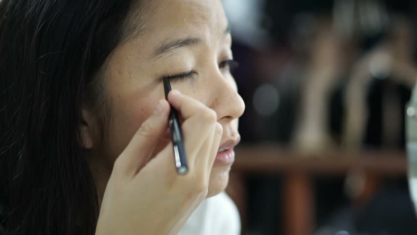 Asian woman doing make up, drawing eyeliner in front of mirror slow motion. Beauty and cosmetic concept | Shutterstock HD Video #28278325