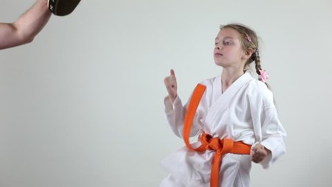 In karategi the sportswoman beats a kick in a jump