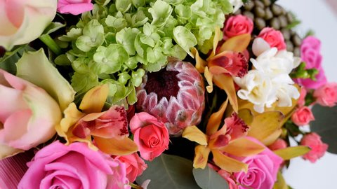 close-up, view from above, Flowers, bouquet, rotation, floral composition consists of Rose aqua, Ornithogalum, Brunia green, eucalyptus, Cymbidium orchid, Protea, Barbatus,