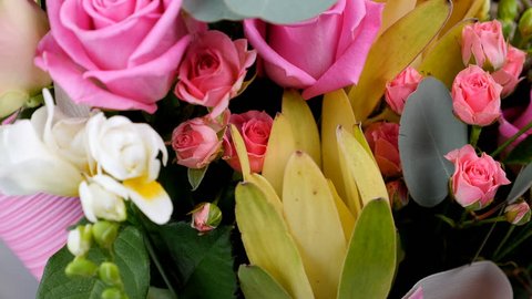 close-up, view from above, Flowers, bouquet, rotation, floral composition consists of Rose aqua, Ornithogalum, Brunia green, eucalyptus, Cymbidium orchid, Protea, Barbatus,