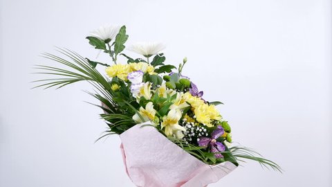 Flowers, bouquet, rotation on white background, floral composition consists of Orchid vanda, Chrysanthemum, Santini , gypsophila, Alstroemeria, aspidistra, Russus,