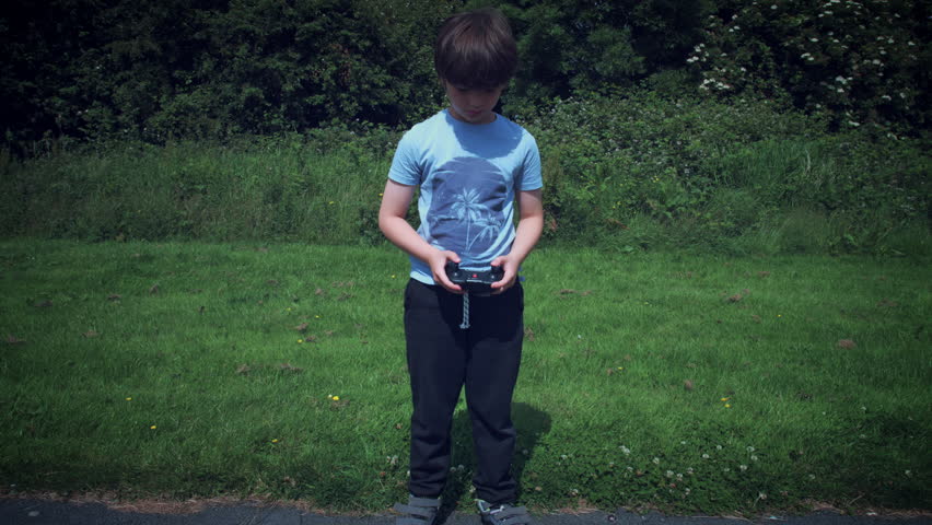 4k Boy Having fun with His Drone Toy, medium shot