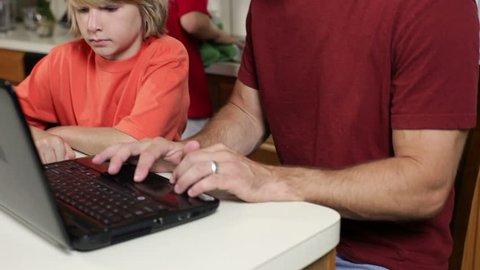 Young parents dealing with the new reality of working from home and helping with online learning during COVID19 school shutdowns.