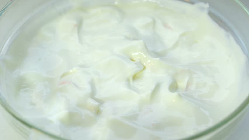 Forest strawberry falling in cream