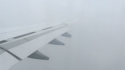Airplane Wings flying through clouds with light turbulence