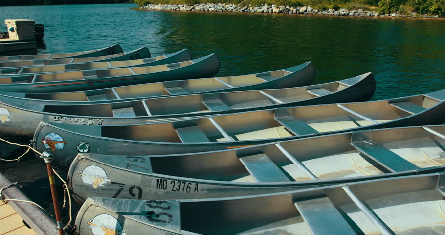 Canoe on a lake pier in the summer, Tracking Shot, 3 Axis Gimbal.