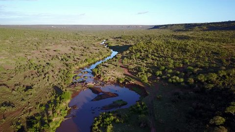 Aerial footage of river flowing through unspoilt wilderness. Kenya, East Africa