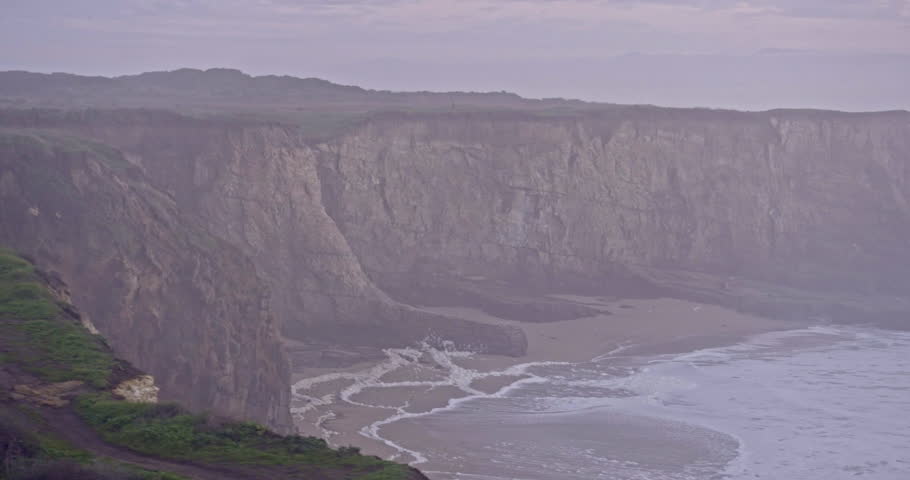 Aerial of People standing at Rock Cliff, Panther Beach Coastline, Coast Dairies State Park, Santa Cruz, California.