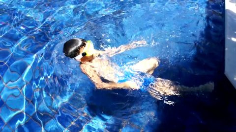 Young boy swimming in the pool