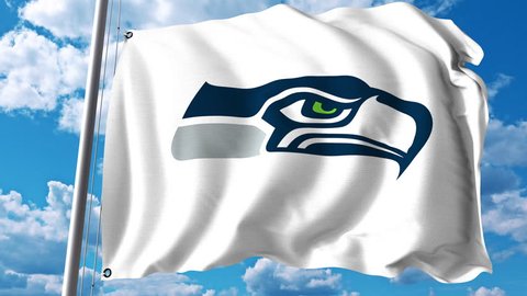 Waving flag with Seattle Seahawks professional team logo. 4K editorial clip