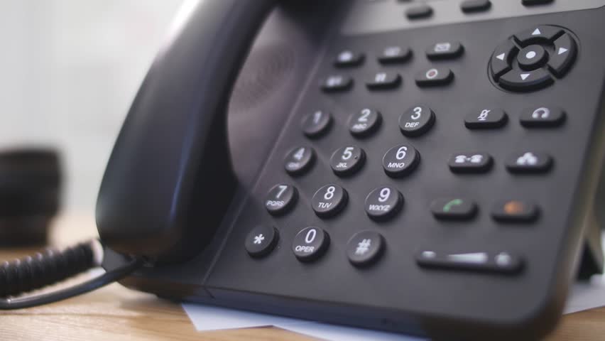 Hand dials the number on the telephone. Woman's hand dials the number close-ups. | Shutterstock HD Video #28304806