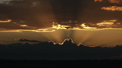 Spectacular sunrises over ominous thunderstorm on the horizon. HD 1080p time lapse.