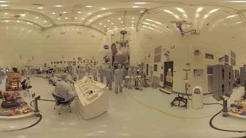 2010s: NASA engineers work on Osiris Rex deep space equipment in a highly controlled clean room environment.