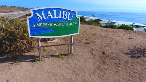 World famous Malibu landmark sign shot by drone in 4K. Beautiful aerial views, low to high, revealing gorgeous Pacific Ocean, Pacific Coast Highway and Malibu, California. Terrific for b-roll clips...