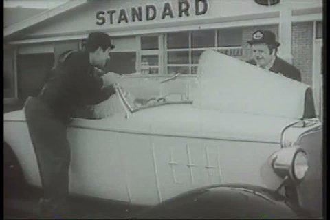 1920s: Laurel and Hardy impersonators work as Standard Oil service station attendants, in a television commercial, in the 1960s.