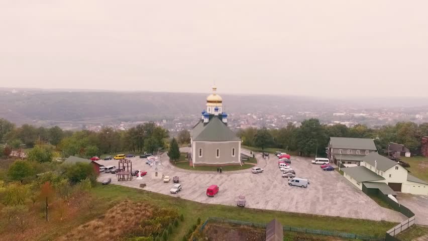Aerial shot of church Khreshchatyk, Zastavna in Ukraine near the precipice.