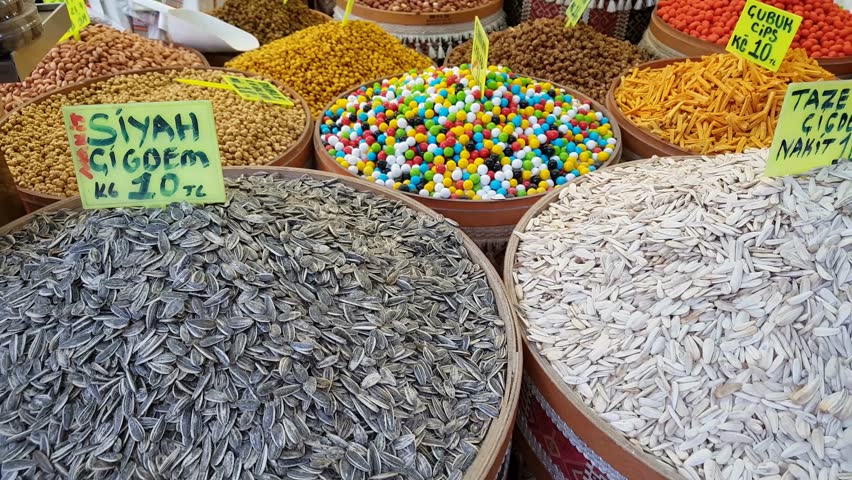 Selection of edible nuts at a Turkish delight shop. Roasted chickpeas with chocolate and mixed nuts for sale at Turkish bazaar. 