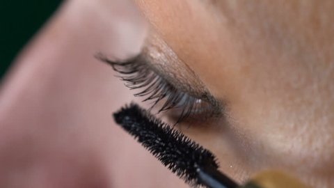 Closeup of woman's eye applying mascara - video in slow motion
