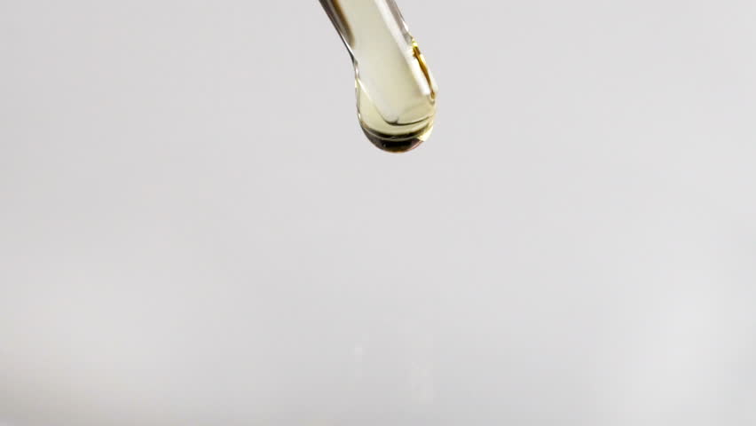 Closeup of liquid oil drop from laboratory pipette to the water over white background Royalty-Free Stock Footage #28336789