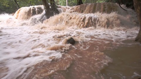 Turbid water waterfall after hard rain in tropical forest, west of Thailand