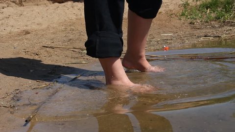 Girl wet feet in water