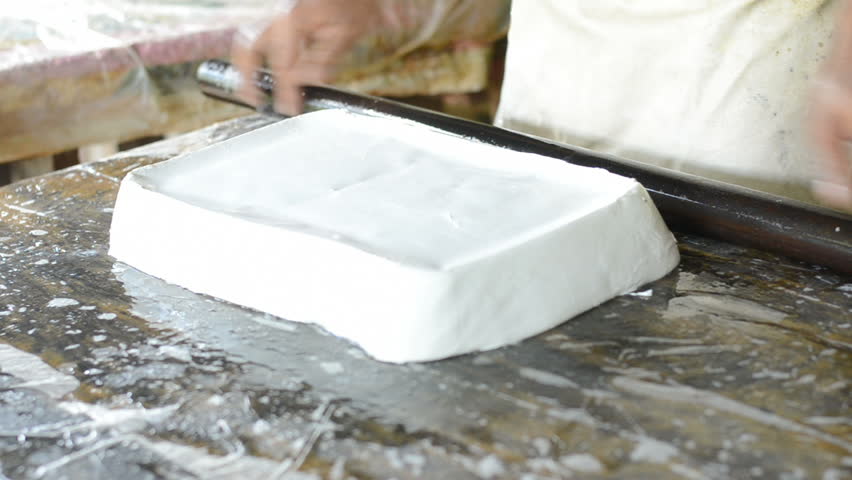 Producing of para rubber series: Worker making raw sheet