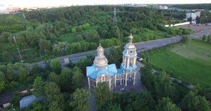 4K aerial video footage view of beautiful Saint Nicholas Mirlikiyskiy cathedral and road area around it in Troekurovo in Moscow, capital of Russia in sunny summer afternoon