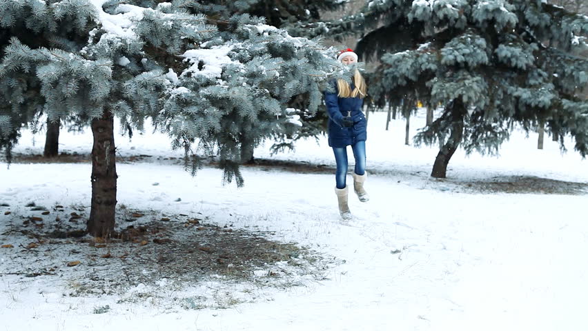 Happy girl  walks in winter wood
