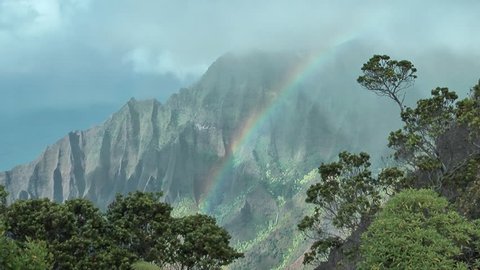 Clouds over Kalalau Valley with rainbow, Kauai, Hawaii