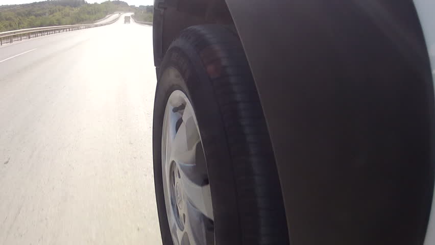 Car wheel is turning in the road