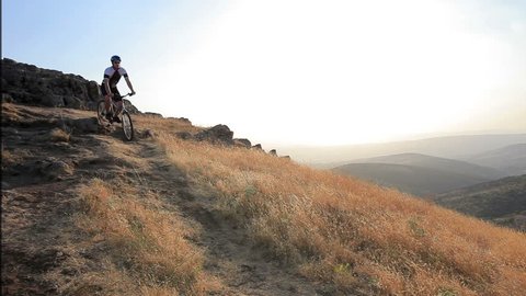 A view of a biker riding a mountain bike on a sunset, Macedonia Stock Video