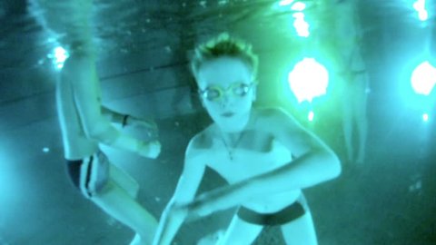 Boy swims under water in pool with swimming goggles Stock Video