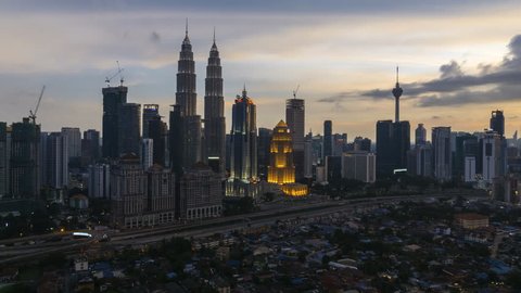 Time lapse: Beautiful and dramatic sunset view of the Kuala Lumpur skyline overlooking the nationals landmark, the petronas twin towers adn KL tower.4KUHD. Motion Timelapse Zoom In.